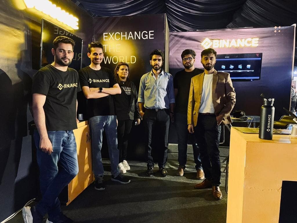 Binance ambassadors posed at a conference activation